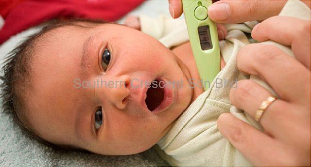 A baby taking temperature
